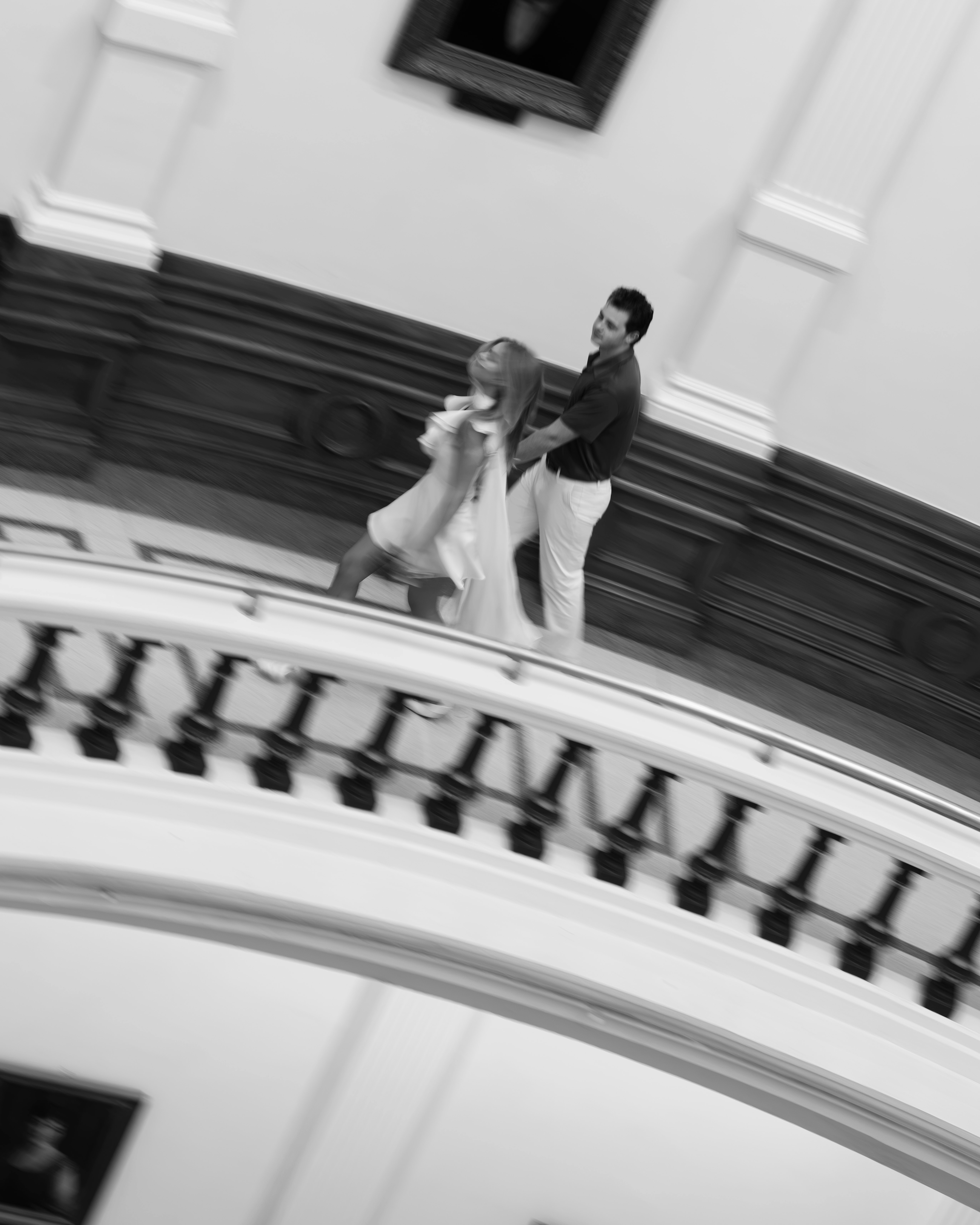Lucy and Bridger on the curved upper balcony, photographed from above